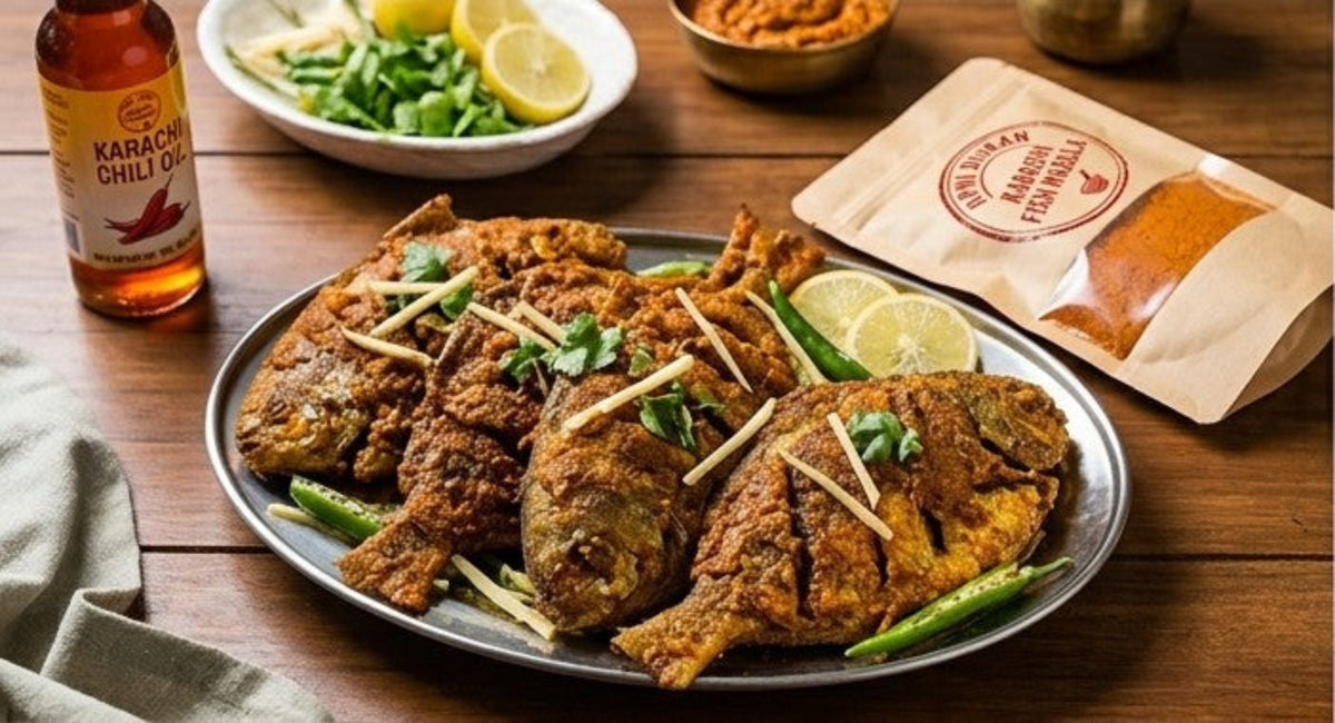 A plated dish of fried fish with green beans and lemon slices on a wooden table, alongside a bottle of Karachi Chili Oil and a branded paper pouch.